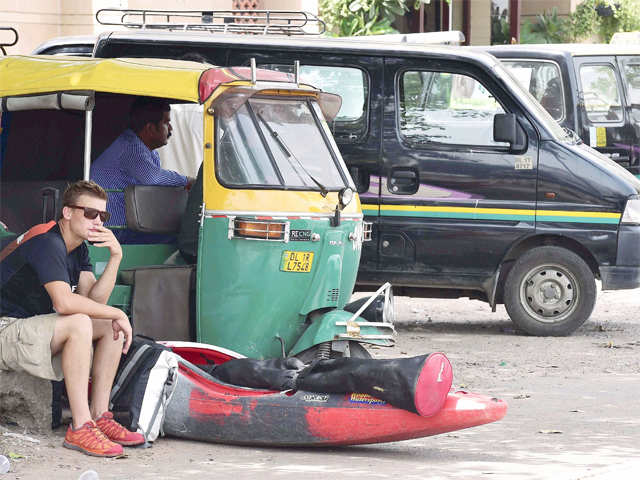 Foreigner sits with his luggage outside railway station