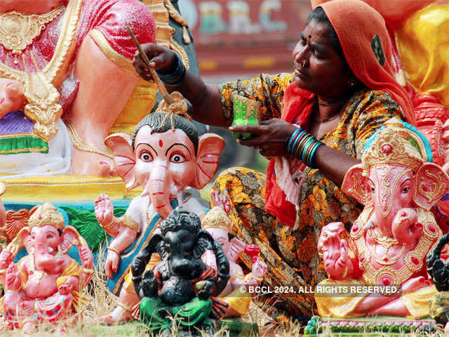 Artist giving final touches to Ganesh idols