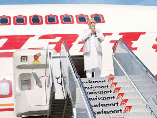 PM Modi gestures before departure for San Jose