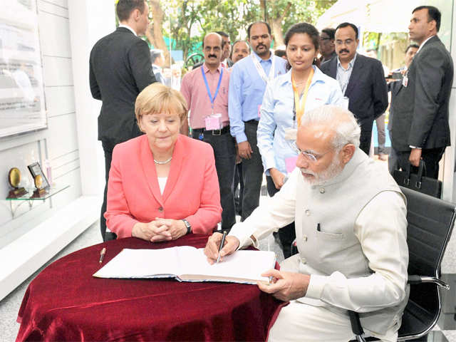 PM Modi & Merkel signing visitors' book