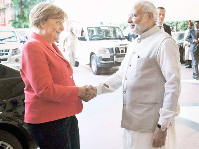 PM Modi and Angela Merkel shaking hands