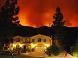 Flames behind a home on Baytree Drive