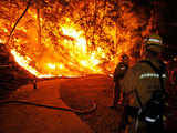 Firefighters look as wildfire spreads