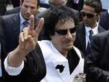 Muammar Gaddafi makes victory sign