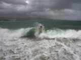 Eduardo Meraz swims amidst crashing waves
