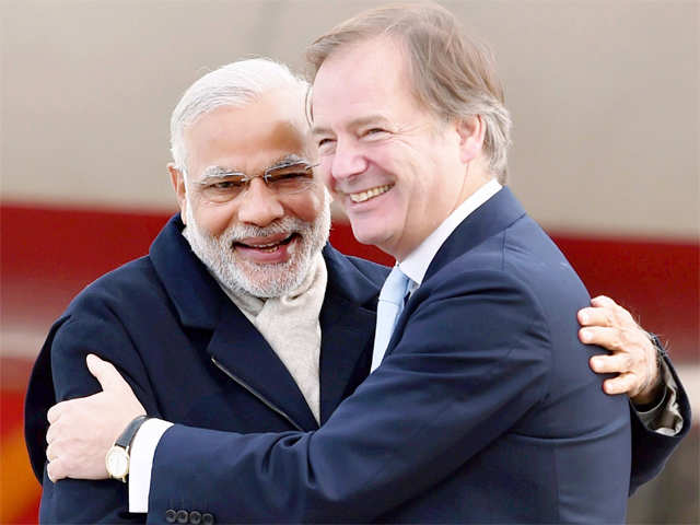 PM Modi is received by Hugo Swire