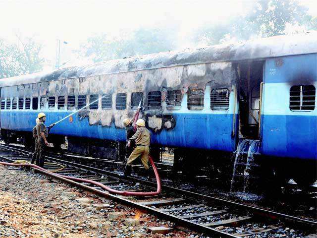 Firemen douse the fire in West Midnapore