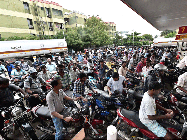 People crowd at a fuel outlet