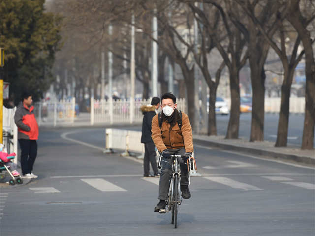 ​A cyclist wears a mask