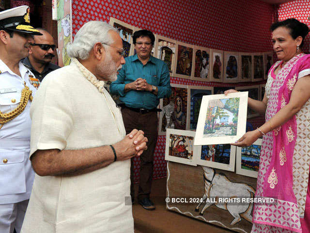 PM Modi looks at a painting