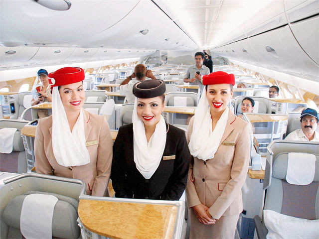 Airhostesses pose inside an Emirates A380 aircraft