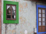 Villager posing behind decorated window