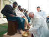 Pope washes feet of Muslim migrants, says 'we are brothers'