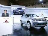 Mitsubishi Motor's President speaks next to PX-MiEV hybrid concept car