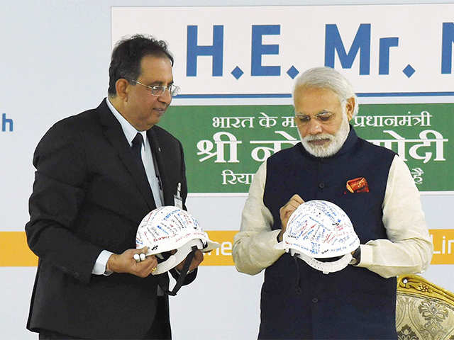 PM Narendra Modi gives autographs on a safety helmet