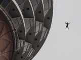 A base jumper free falls from the Menara Kuala Lumpur Tower