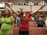 People pray at church in Arkansas