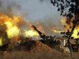 A mobile artillery unit fires a shell towards Gaza