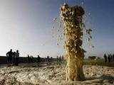 Plume of sea spray blows out of a stormwater drain