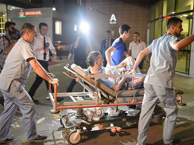 ​Medics carry wounded people