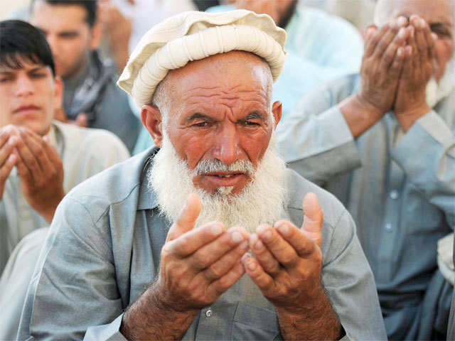 Afghan man attends Eid al-Fitr prayers