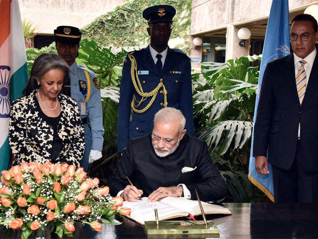 PM signing the visitors' book at the UN Office