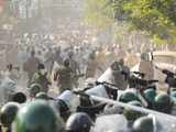 Policemen chase residents and students