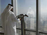 An Emirati man watches the city view