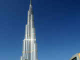 Emirati men walk past Burj Dubai