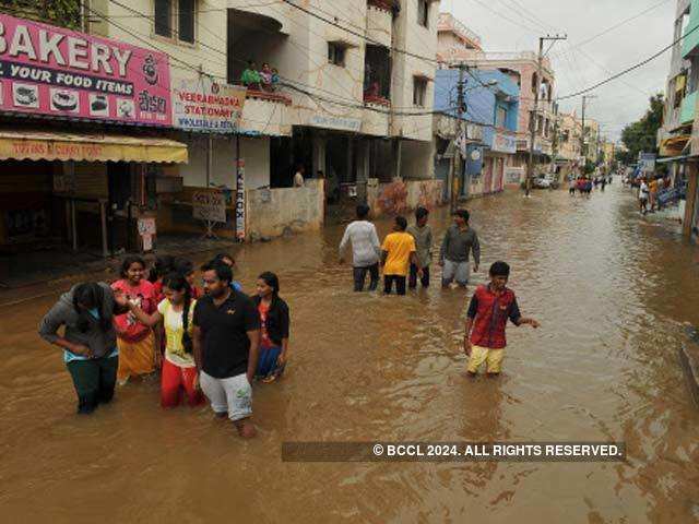 Residents have to wade through knee-deep water