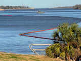 Booms stretch along the river front