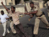 Policemen try to restrain a Shiv Sena activist