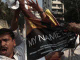 Shiv Sena activists tear a poster