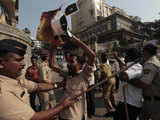 Policemen try to restrain Shiv Sena activists