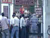 To exchange currency notes, people queue up outside banks