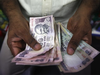 Rupee opens 5 paise up at 68.11 against dollar