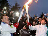 Arnold Schwarzenegger passes Olympic flame