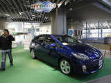 Man walks past newest Prius hybrid car