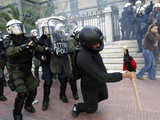 Greek policemen arrest a demonstrator