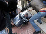 A demonstrator clashes with riot police