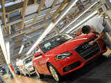 An employee polishes the radiator grill of an Audi car