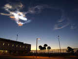 Exhaust, smoke swirls over Kennedy Space Center