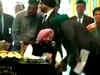 Overwhelmed Sidhu touches Amarinder Singh’s feet after being sworn in as minister