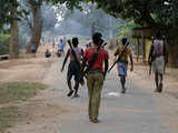 Police officers walking at a Salwa Judum