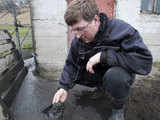 A farmer checks volcanic ash