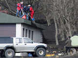 A rescue team clears volcanic ash