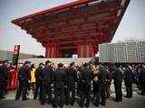 Visitors wait to enter Shanghai World Expo site