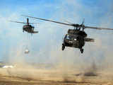 Helicopters airlift sling load sand bags