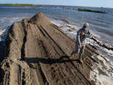 Captain James Hoover walks along an earthen barrier