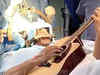 Musician suffering from abnormal muscle condition plays guitar during brain surgery